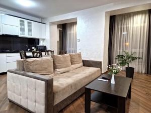 a living room with a couch and a table at Modern apartment on Belvedere in Ivano-Frankivsk