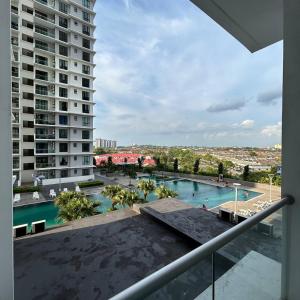 a view of a swimming pool from a balcony of a building at Paradigm Mall 1BR-Poolview-Netflix-WiFi by JB RelaX Homestay in Johor Bahru