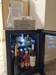 a refrigerator filled with lots of bottles of alcohol at La casa al mare, Pittulongu in Olbia
