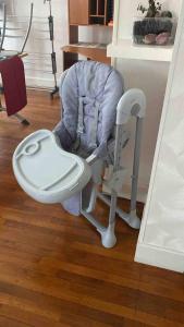 a baby chair with a toilet in a room at appartement t3 terrasse in Troyes +10 photos