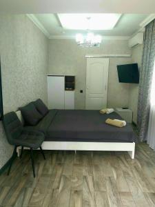 a bedroom with a large bed and a chair at White House in Bălţi