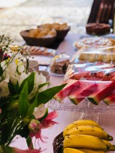 a table with a bunch of food on it at Pousada Antares de Paraty in Paraty