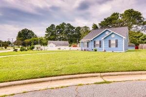 a blue house on a green grassy field at Greensboro Vacation Rental with Patio, Yard! in Greensboro