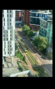 an aerial view of a city street with a bus at Stylish Media city Manchester apartment in Manchester