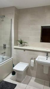 a bathroom with a toilet and a sink at Stylish Media city Manchester apartment in Manchester