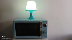 a lamp sitting on top of a television with a lamp on top at FLORAC AUTHENTIQUE in Florac Trois Riviere