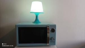 a lamp sitting on top of a television with a lamp on top at FLORAC AUTHENTIQUE in Florac