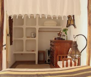 a bedroom with a bed and a dresser in a room at Riad Baladin in Essaouira