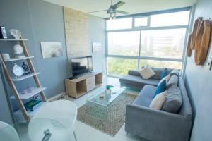 a living room with a couch and a tv at Ballito Vacation Pad Ac Unit With Sea Views in Ballito