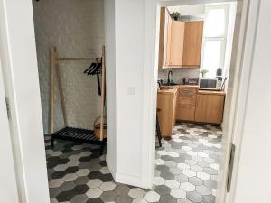 a kitchen with a black and white checkered floor at Sopot blisko plaży 4 in Sopot