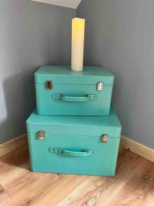 a stack of three suitcases with a candle on top at Castle View Suite in Sligo