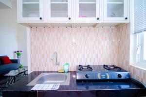 a kitchen with a sink and a stove at Villa Leora Cordoba G2 by Sans Villa in Tlekung