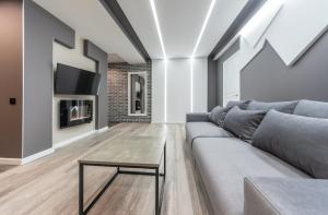 a living room with a couch and a table at Luxrent Apartments on Lesi Ukrainki - Kiev in Kyiv