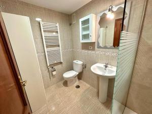 a small bathroom with a toilet and a sink at La Piragua in Ribadesella +31 photos