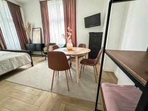 a living room with a table and chairs in a room at Sopot C 200m do plaży in Sopot +19 photos