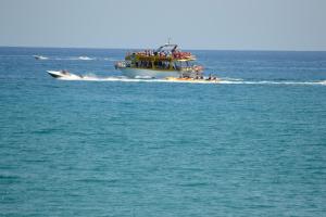 a group of people on a boat in the water at Hotel Thisvi in Stalís