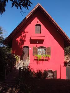 帕蒂杜阿爾費里斯的住宿－Amaencanto，红色的房子,窗户和鲜花