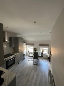 a kitchen and dining room with a table and chairs at Westland Suites - Stylish, Modern, Elegant, Central Apartments A in Derry Londonderry