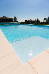 a large swimming pool with blue water at B&B Spina Verde in Como