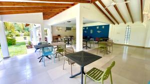 a dining room with tables and chairs in a house at La Modestie Guest House in Grand'Anse Praslin