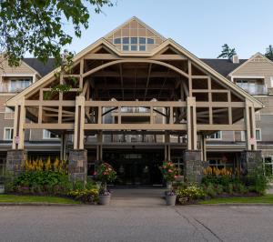 a building with a large wooden structure at Grand Summit Hotel at Attitash in Bartlett