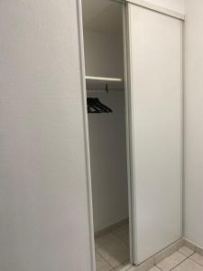 a closet with a sliding glass door with a mirror at Appt Longwy, super bien situé in Longwy