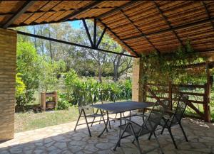 patio ze stołem i krzesłami pod pergolą w obiekcie Haasienda 