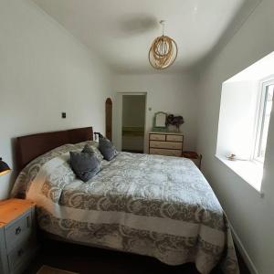 a bedroom with a large bed and a window at Peaceful and Stunning Waterside Location in Helensburgh