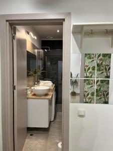 a bathroom with two sinks and a counter with a mirror at Green Divine Apartament in Popeşti-Leordeni
