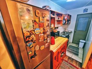 a kitchen with a refrigerator with magnets on it at Departamento Equipado Parejas in Coquimbo