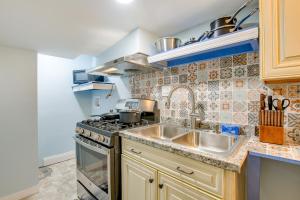a kitchen with a sink and a stove at Splendid Hyattsville Home 7 Mi to Capitol! in Hyattsville