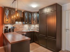 a kitchen with brown cabinets and a wooden counter top at Beliebte Ferienwohnungen in Flensburg in Flensburg +9 photos