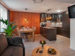 a kitchen and living room with a couch and a table at Beliebte Ferienwohnungen in Flensburg in Flensburg