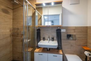 a bathroom with a sink and a shower at Haus Nani in Bad Gastein +15 photos