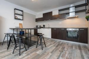 a kitchen with a table and some stools in it at Kuća za odmor Kamenjani-Škabrnja in Škabrnje