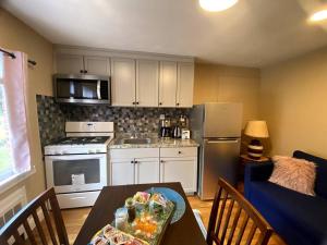 a small kitchen with a table and a blue couch at Cozy Boston Getaway Apartment Perfect for 2026 World Cup Visit, Free Parking in Boston