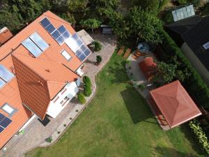 an overhead view of a house with solar panels on it at Pensjonat Srebrny Klon in Bytów