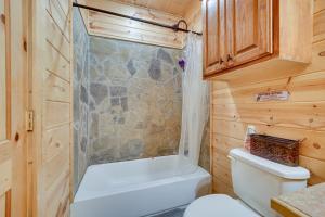 a bathroom with a shower and a toilet and a tub at Fort Towson Cabin Less Than 1 Block to Raymond Gary Lake in Fort Towson
