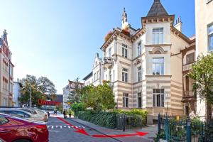 a building with a red ribbon in front of it at So in Sopot Apartments in Sopot