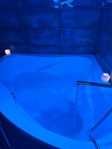 a bath tub with a blue light in a bathroom at Arnautskaya apartments in Odesa