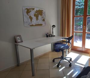 a desk in a room with a chair and a map at Waldwinkel in Treuchtlingen