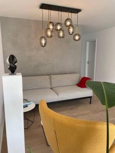 a living room with a couch and a table at Alma - Art Luxus Modern Ambiente in Karlsruhe