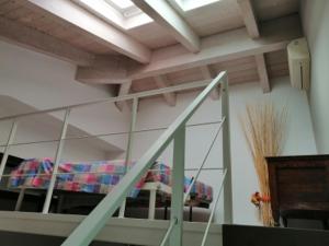 a room with a bunk bed and a staircase at Appartamento Vivaldi! in Cento
