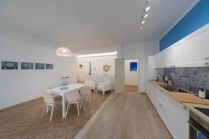 a kitchen and dining room with a table and chairs at Majú Home in Maiori