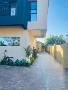 a building with a walkway next to a building at Central Gabs Oasis: 2BR-Retreat in Gaborone