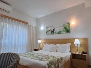 a hotel room with a bed and a window at Hotel SQUARE in Sertã +41 photos
