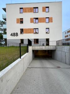 an external view of a building with a walkway at Apartament 25 Rowery, Spacery w Dolinie Baryczy - 5D Apartamenty in Milicz