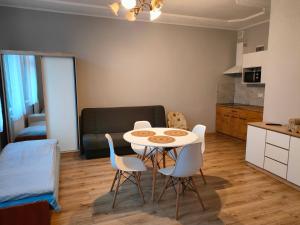 a kitchen and dining room with a table and chairs at Agroturystyka Goliat 