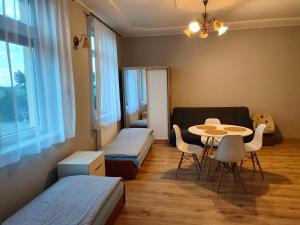 a room with two beds and a table and chairs at Agroturystyka Goliat in Zapolice