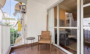 a room with a chair and a table and a window at Tabas Apê estiloso no Jardim Botânico JB0002 in Rio de Janeiro